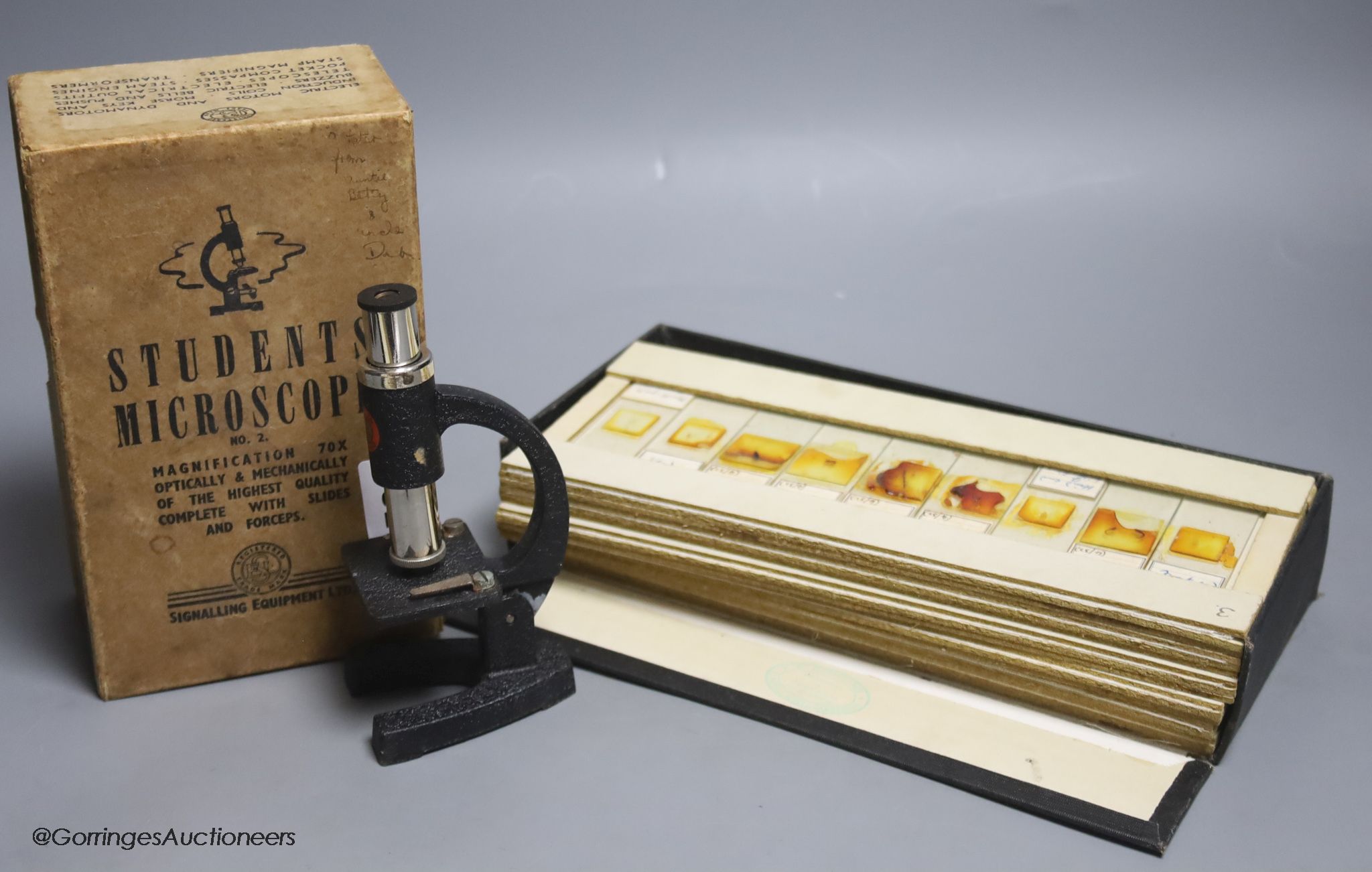A case of early 20th century microscopes slides and a student's microscope